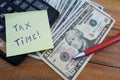 Time taxes, on the table is a calculator and money dollars Royalty Free Stock Photo