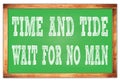 TIME AND TIDE WAIT FOR NO MAN words on green wooden frame school blackboard