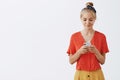 Time to answer my followers. Portrait of relaxed, pleased and calm good-looking blond woman in v-neck vintage polka-dot