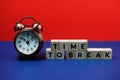 Time to Break alphabet letter with alarm clock on blue and red background Royalty Free Stock Photo