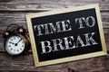 Time to Break word with alarm clock on wooden background