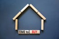 Time to buy house symbol. Concept words `Time to buy` on wooden blocks near miniature house. Beautiful grey background, copy spa Royalty Free Stock Photo