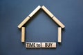 Time to buy house symbol. Concept words `Time to buy` on wooden blocks near miniature house. Beautiful grey background, copy spa Royalty Free Stock Photo