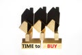 Time to buy house symbol. Concept words `Time to buy` on wooden blocks near miniature houses from shadows. Beautiful white Royalty Free Stock Photo