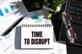 TIME TO DISRUPT text, written on a notepad with laptop, pen on the chart background Royalty Free Stock Photo