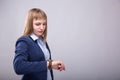 Time to do business. Thoughtful young woman in smart casual wear checking the time. Model look to the watch