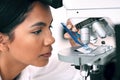 Time to do some serious investigation. Closeup shot of an attractive young female scientist placing a microscopic slide Royalty Free Stock Photo