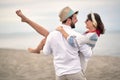 Time to enjoy outdoors. Young couple in an embrace.Romantic man and woman on sea beach Royalty Free Stock Photo