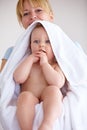 Time to get dressed, little man. a mother carrying her baby boy in a towel. Royalty Free Stock Photo