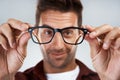 Time to get my vision back. Portrait of a cheerful young man wearing glasses and smiling brightly while standing against Royalty Free Stock Photo