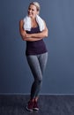 Time to get sweaty. Studio portrait of an attractive mature woman in sportswear standing with a towel around her neck Royalty Free Stock Photo