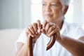 Time to get up and go. Closeup shot of a senior woman holding her cane while sitting in the old age home. Royalty Free Stock Photo