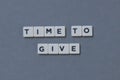 ' Time To Give ' word made of square letter word on grey background