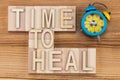 Time to heal- text in vintage letters on wooden blocks with ala