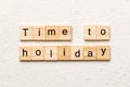 Time to holiday word written on wood block. Time to holiday text on cement table for your desing, concept Royalty Free Stock Photo