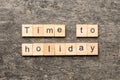 Time to holiday word written on wood block. Time to holiday text on cement table for your desing, concept Royalty Free Stock Photo