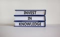 Time to invest in knowledge. Books with text `invest in knowledge` on beautiful white background. Business and invest in knowled