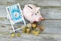 Time to invest your savings concept with pile of money , alarm clock and piggy bank Royalty Free Stock Photo