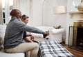 Time to lay back and relax with my love. an affectionate senior couple enjoying some wine together at home. Royalty Free Stock Photo