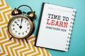 Time to learn something new text on notepad paper and alarm clock Royalty Free Stock Photo