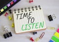 Time to listen symbol. Concept words Time to listen on white notebook. Beautiful wooden background. Business and Active listening Royalty Free Stock Photo