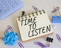 Time to listen symbol. Concept words Time to listen on white notebook. Beautiful wooden background. Business and Active listening Royalty Free Stock Photo