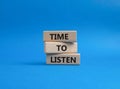 Time to listen symbol. Wooden blocks with words Time to listen. Beautiful blue background. Business and Active listening concept. Royalty Free Stock Photo