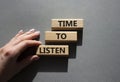 Time to listen symbol. Wooden blocks with words Time to listen. Beautiful grey background. Businessman hand. Business and Active Royalty Free Stock Photo