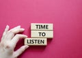 Time to listen symbol. Wooden blocks with words Time to listen. Beautiful red background. Businessman hand. Business and Active Royalty Free Stock Photo