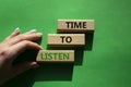 Time to listen symbol. Wooden blocks with words Time to listen. Beautiful green background. Businessman hand. Business and Active Royalty Free Stock Photo