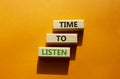 Time to listen symbol. Wooden blocks with words Time to listen. Beautiful orange background. Business and Active listening concept Royalty Free Stock Photo