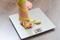 Time to lose kilograms with woman feet stepping on a weight scale Royalty Free Stock Photo