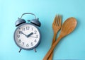 Time to lose weight , eating control or time to diet concept , a alarm clock decoration on blue background Royalty Free Stock Photo