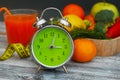 Time to lose Weight. Fruit, Vegetable and and glass of juice Alarm Clock on the table, Diet and Fitness concept. Royalty Free Stock Photo