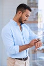 Time to make a change. a young businessman checking the time on his watch. Royalty Free Stock Photo