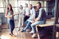 Time to make conclusions. Beautiful young woman standing near whiteboard and pointing on the chart while her coworkers Royalty Free Stock Photo