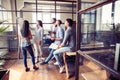 Time to make conclusions. Beautiful young woman standing near whiteboard and pointing on the chart while her coworkers Royalty Free Stock Photo