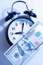 Time to make money. Alarmclock with Dollars cash as symbol of bu Royalty Free Stock Photo