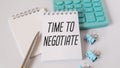 Time to negotiate text on the notepad page on a white background next to it is a black marker. Royalty Free Stock Photo