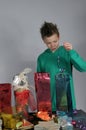 Boy wrapping up christmas gifts