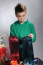 Boy wrapping up christmas gifts