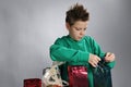 Boy wrapping up christmas gifts