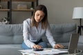 Young lady flat owner engaged in housekeeping at home office