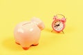 It is time to pay. Credit debt. Piggy bank pink pig and little alarm clock. Financial crisis. Economics and finance Royalty Free Stock Photo