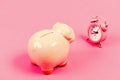 It is time to pay. Piggy bank pink pig and little alarm clock. Financial crisis. Economics and finance. Banking account Royalty Free Stock Photo