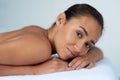 Time to relax. Portrait of a beautiful young woman relaxing on a massage table at a spa. Royalty Free Stock Photo