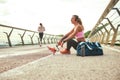 Time to relax. Side view of young beautiful woman in headphones with leg prosthesis listening music and looking aside Royalty Free Stock Photo