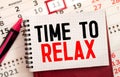 TIME TO RELAX text in notebook on gray background next to pencils and paper clips. Concept. Royalty Free Stock Photo
