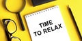 Time to relax word written on notepad on office table Royalty Free Stock Photo