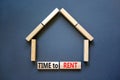 Time to rent house symbol. Concept words `Time to rent` on wooden blocks near miniature house. Beautiful grey background, copy Royalty Free Stock Photo